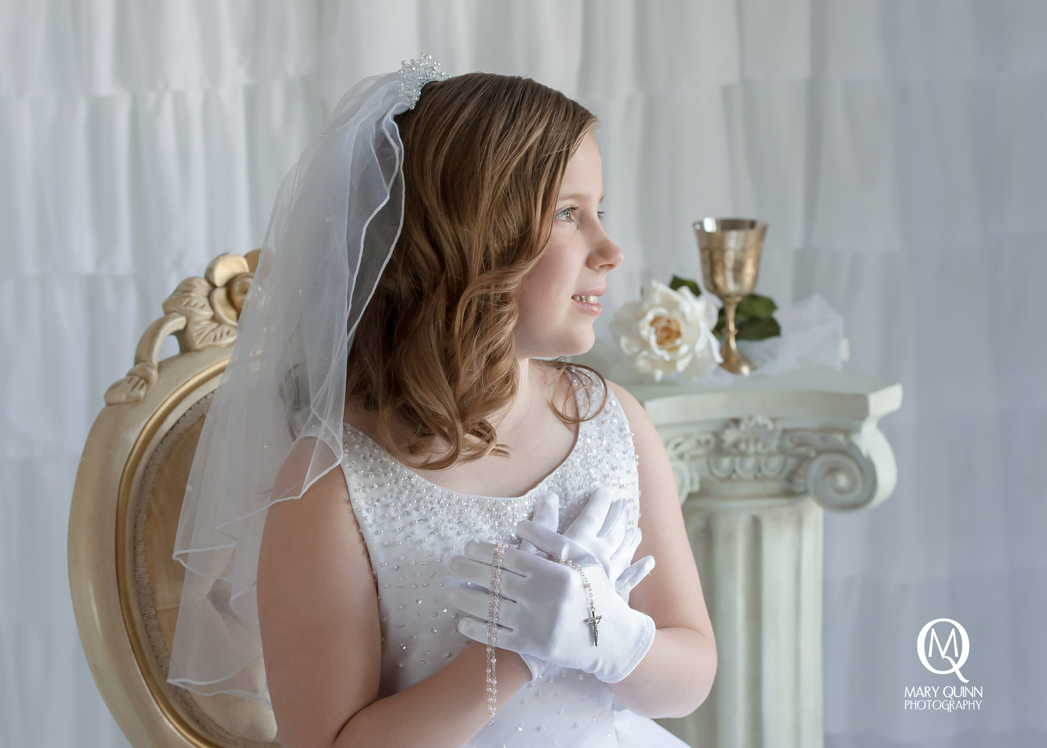 First Holy Communion girl with rosaries on a white backdrop in Marlton, New Jersey studio.