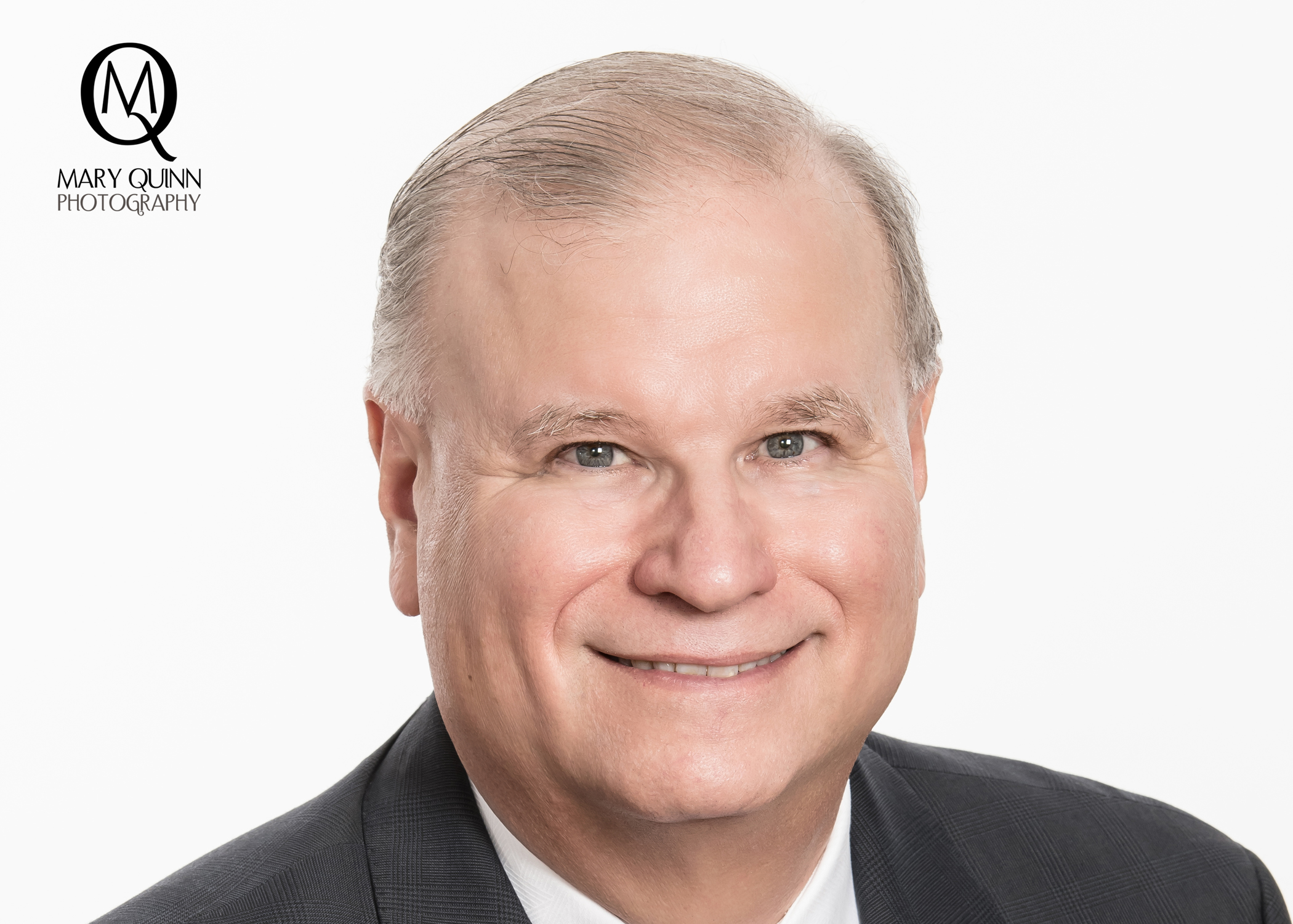 Attorney headshot image of a man with a pleasant smile on a white backdrop in Mary Quinn Photography Inc's studio located in Marlton, New Jersey.