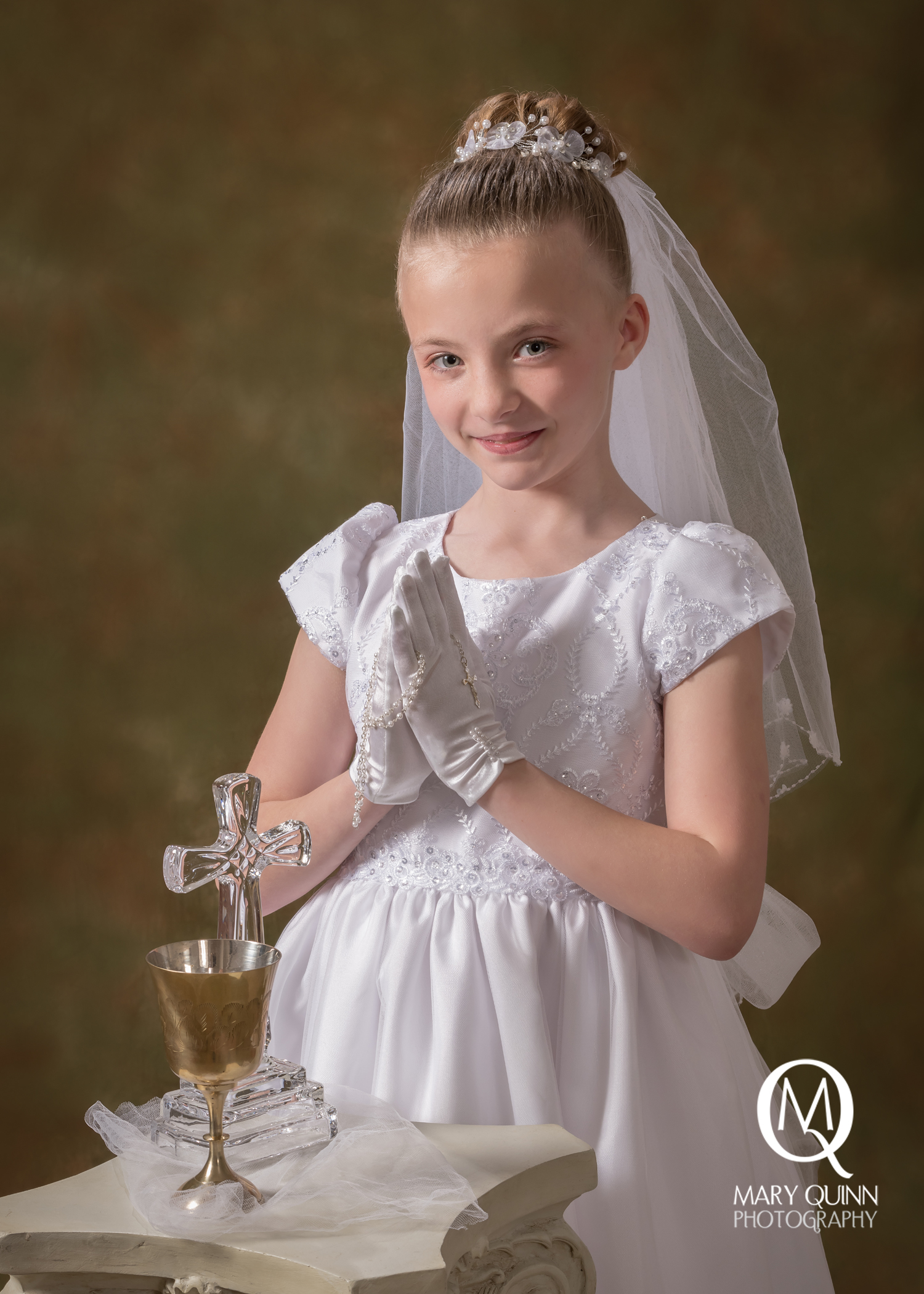 First Communion girl smiling photo taken in a Marlton, New Jersey studio.
